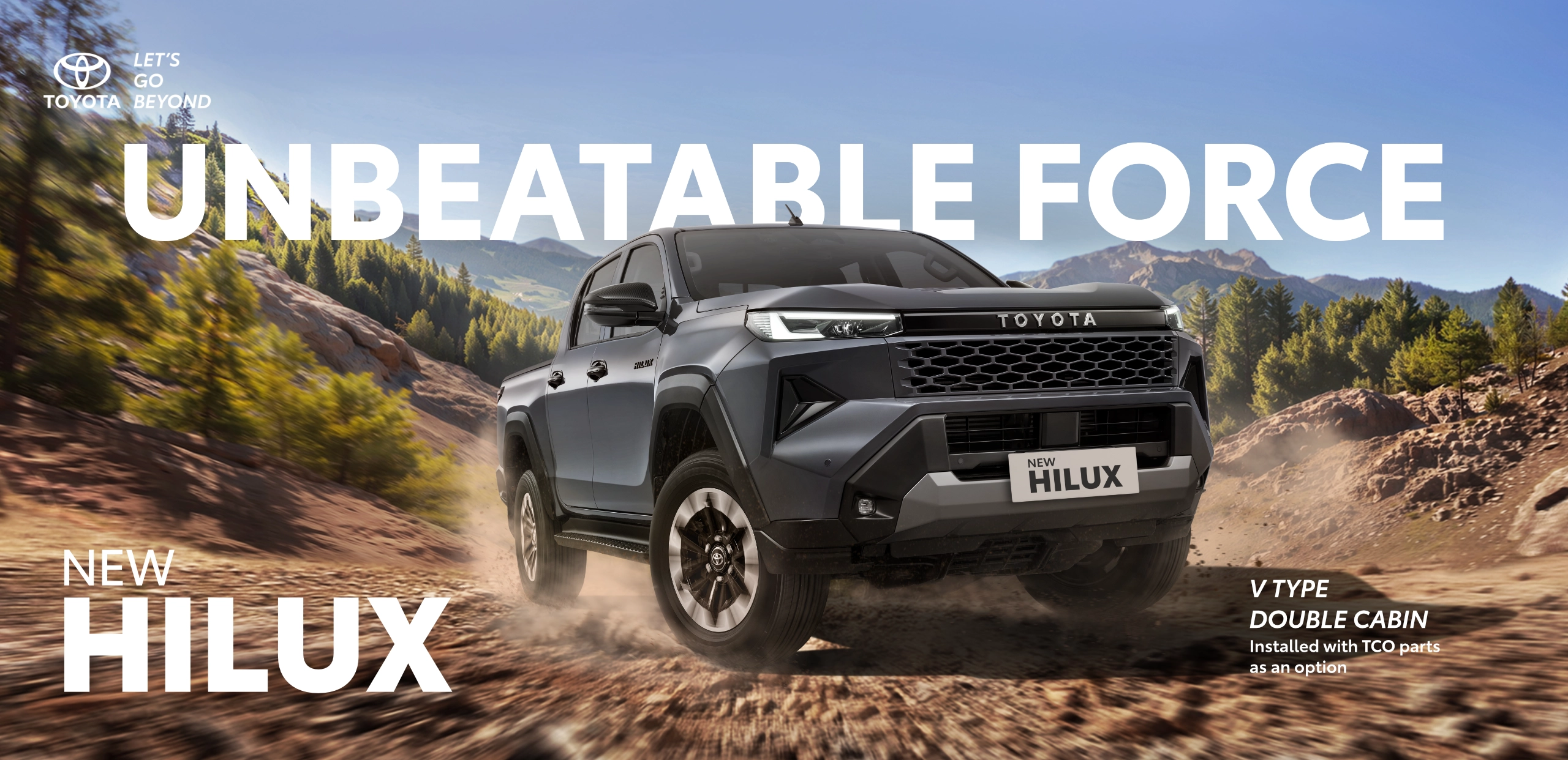 Banner promosi Toyota New Hilux Double Cabin Tipe V warna abu-abu yang melaju tangguh menerjang jalanan tanah berdebu di area pegunungan, memuat tagline utama Unbeatable Force.