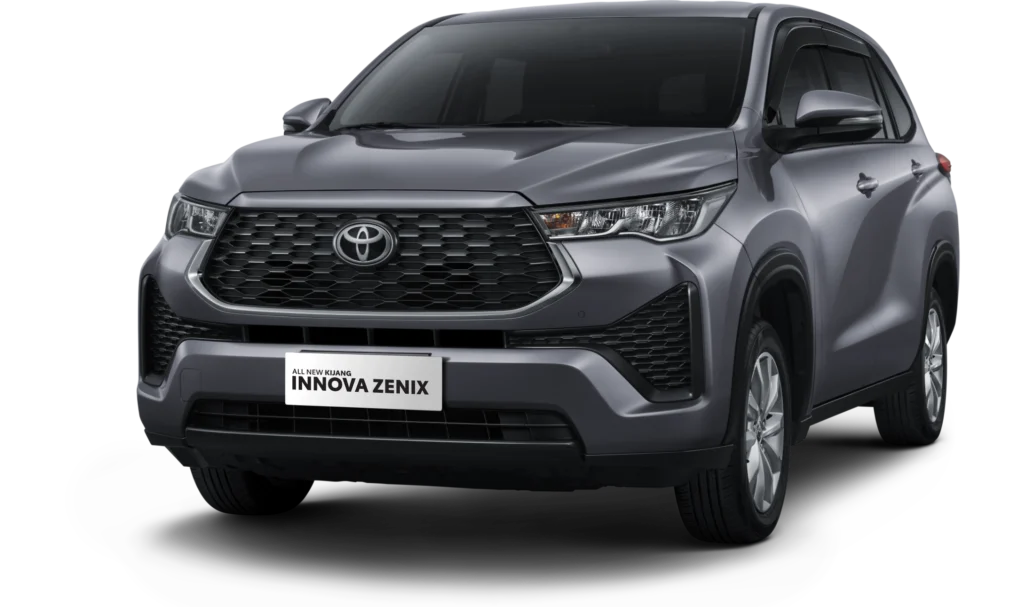 Mobil Toyota All New Kijang Innova Zenix varian mesin bensin (gasoline) warna abu-abu, tampak serong depan menonjolkan grille heksagonal besar yang tangguh dan desain MPV crossover berlatar belakang hitam pekat.