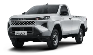 Mobil pikap komersial Toyota New Hilux Single Cabin varian warna putih, tampak serong depan menonjolkan desain tangguh, bumper depan kokoh, dan bak muatan luas berlatar belakang hitam pekat.