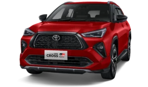 Mobil compact SUV Toyota All New Yaris Cross varian tertinggi S Gasoline dengan aksesoris GR Parts warna merah two-tone (atap hitam), tampak serong depan menonjolkan desain fascia sporty agresif berlatar belakang hitam pekat.