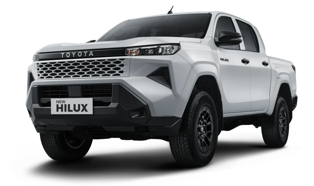 Mobil pikap kabin ganda Toyota New Hilux Double Cabin varian Tipe E 4x4 transmisi manual warna putih, tampak serong depan menonjolkan desain tangguh fungsional berlatar belakang hitam pekat.