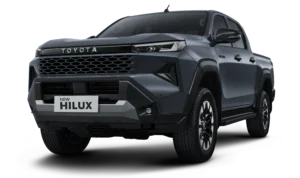 Mobil pikap kabin ganda Toyota New Hilux Double Cabin varian tertinggi Tipe V 4x4 transmisi otomatis warna abu-abu, tampak serong depan menonjolkan desain premium berlatar belakang hitam pekat.